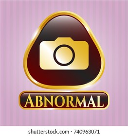  Golden emblem or badge with photo camera icon and Abnormal text inside