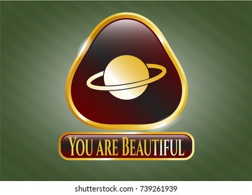  Golden emblem or badge with planet, saturn icon and You are Beautiful text inside