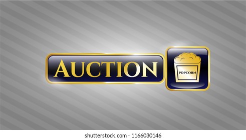  Golden emblem or badge with popcorn icon and Auction text inside