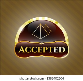  Golden emblem or badge with pyramids icon and Accepted text inside