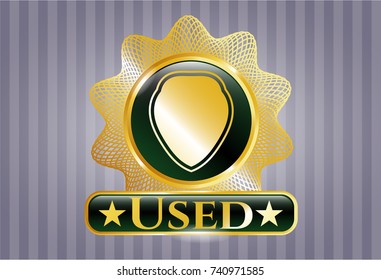  Golden emblem or badge with shield icon and Used text inside