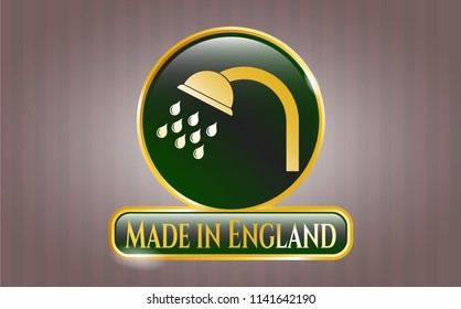  Golden emblem or badge with shower icon and Made in England text inside