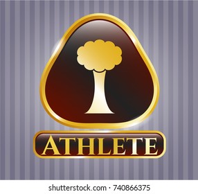  Golden emblem or badge with tree icon and Athlete text inside