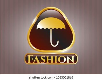   Golden emblem or badge with umbrella icon and Fashion text inside