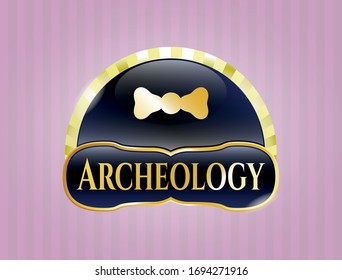  Golden emblem with bow tie icon and Archeology text inside