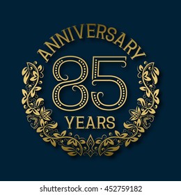 Golden emblem of eighty fifth years anniversary. Celebration patterned logotype with shadow on blue.