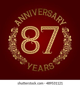 Golden emblem of eighty seventh anniversary. Celebration patterned sign on red.