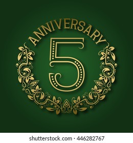 Golden emblem of fifth anniversary. Celebration patterned logotype with shadow on green.