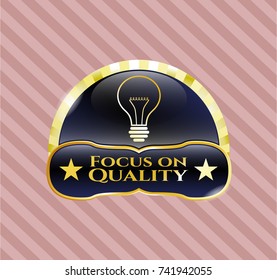  Golden emblem with idea icon and Focus on Quality text inside