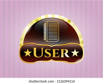  Golden emblem with note book icon and User text inside