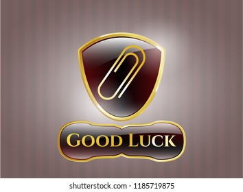  Golden emblem with paper clip icon and Good Luck text inside
