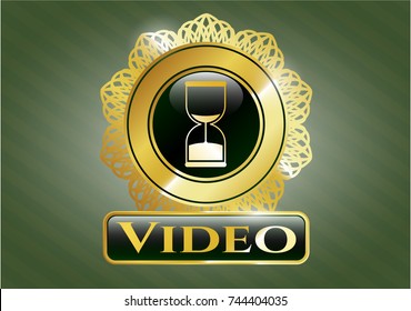  Golden emblem with sand clock icon and Video text inside