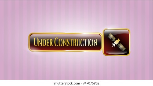  Golden emblem with satelite icon and Under Construction text inside