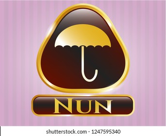  Golden emblem with umbrella icon and Nun text inside