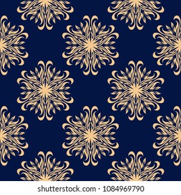 Golden floral design on dark blue background. Seamless pattern for textile and wallpapers