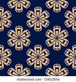 Golden floral ornament on dark blue background. Seamless pattern for textile and wallpapers