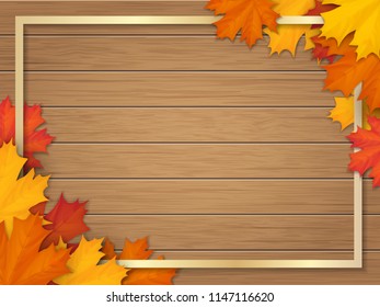 Golden frame decorated of fallen maple leaves. Autumn foliage on the background of a wooden vintage table surface. Realistic vector illustration.