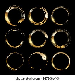 Golden frames made of brush stroke rings isolated on black background. Vector design elements set