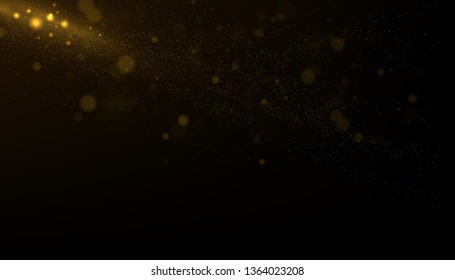 Golden glitter dust on dark background. 