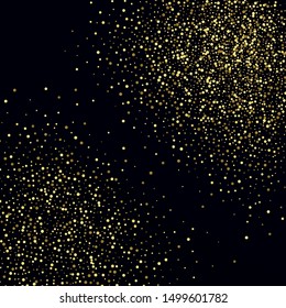 Golden glitter particles on a black background. Holiday abstract background.
