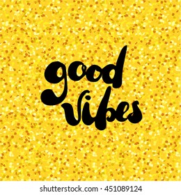 Golden glitter texture background with handwritten text "Good vibes". Vector illustration