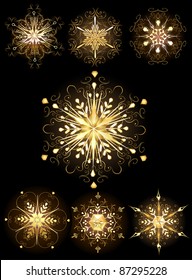 golden, glittering, jewelry snowflakes on a dark background.