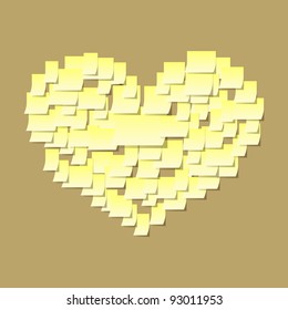 Golden heart made of sticky notes on a cork board