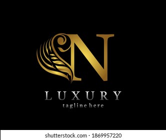 Golden initial N letter luxury beauty flourishes ornament monogram logo