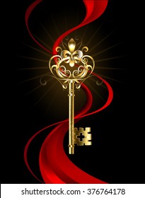 Golden key decorated with the fleur de lis jewelry entwined with red silk ribbon on black background. 