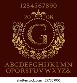 Golden lattice patterned letters and numbers with initial monogram in coat of arms form. Decorative font and elements kit for logo design.