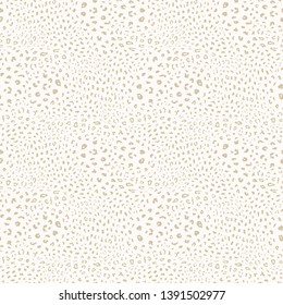 Golden leopard print pattern. Vector seamless background. Subtle animal skin texture of jaguar, leopard, cheetah, panther, puma. White and gold pattern with spots. Repeated design for decor, textile