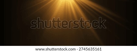 Golden light rays shining from top corner on dark black background