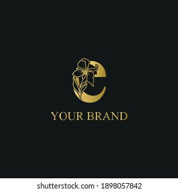 Golden Luxury Initial letter e with February Iris flower for cosmetic, Jewelry, boutique, hotel logo concept vector	