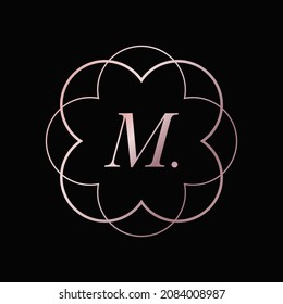 Golden luxury vector logo design in flower or mandala shape with letter M. Massage and spa logo.