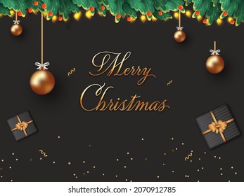 Golden Merry Christmas Font With 3D Bronze Baubles Hang, Gift Boxes, Berries, Leaves And Lighting Garland Decorated Black Background.