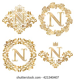 Golden N letter vintage monograms set. Heraldic coats of arms and round frames.