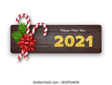Golden numbers 2021 on wood background. Holiday gift card Happy New Year with fir tree branches, candy canes and bow. Celebration decor. Vector template illustration.