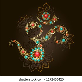 Golden Om symbol adorned with precious flowers with cornelian and turquoise on brown background.
