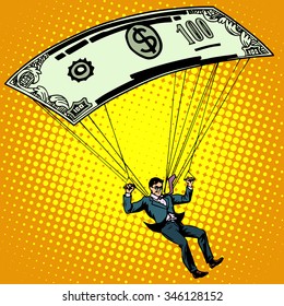 Golden Parachute Business Concept Cash Compensation Pop Art Retro Style. A Man Descends By Parachute Money Banknote One Hundred Dollars. Financial Success And Good Profit