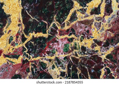 Golden patina on an unusual stone texture, fragment of a stone cut, red and green with gold, stone texture collage, spectacular texture with veins, for background, wallpaper, self-adhesive, interiors