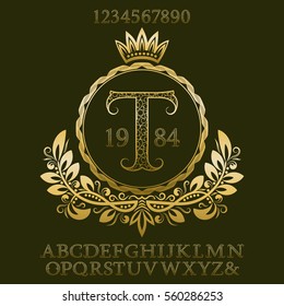 Golden patterned letters and numbers with initial monogram in coat of arms form. Elegant font and elements kit for logo design.