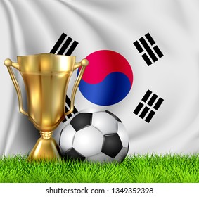 Golden realistic winner trophy cup and soccer ball isolated on national Korea South flag. National team is the winner of the football. Cup winner in the form of a golden bowl. Sport design background.
