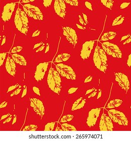 A golden and red seamless pattern with stylized leaves of wild grape