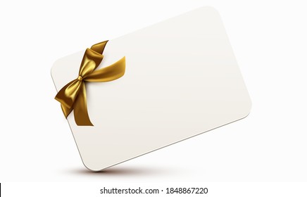 Golden ribbon with bow wrapped around a white rectangular card