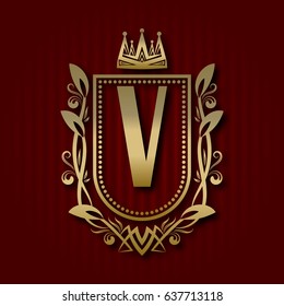 Golden royal coat of arms in medieval style. Vintage logo with V monogram.