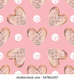 Golden seamless pattern with the image of tribal hearts. Gold hand drawn heart for the modern design.