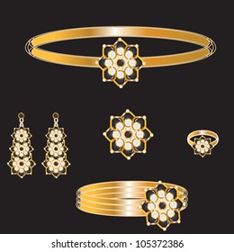 golden set from necklace ring earrings brooch and bracelets with white and black stones on black background