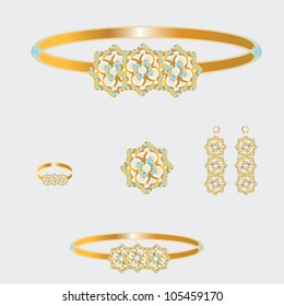 golden set from necklace ring earrings brooch and bracelets with blue and white stones on grey background