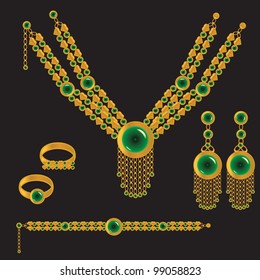 golden set from necklace rings earrings and bracelet with green stone on black background