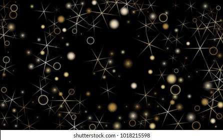 Golden Snowflakes. Christmas Confetti. Festive Background with Yellow and Orange Bokeh and Stars. New Year Background with Gold Glitter made of Snowflakes and Stars. Confetti on Black Backdrop
